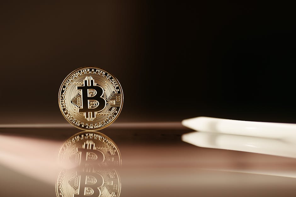 A close-up image of a Bitcoin coin reflecting on a shiny surface, highlighting cryptocurrency themes